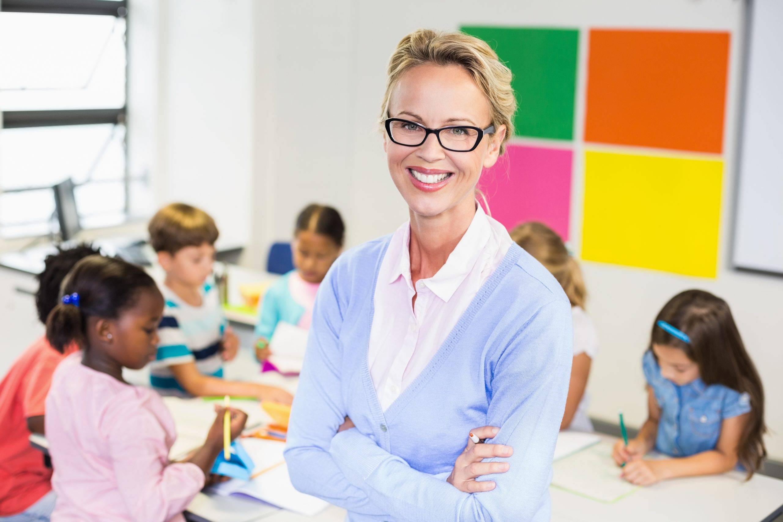 portrait-of-teacher-standing-in-classroom-2023-11-27-05-37-16-utc-scaled.jpeg